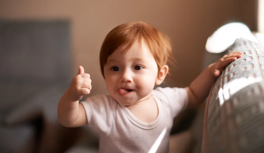 toddler giving thumbs up