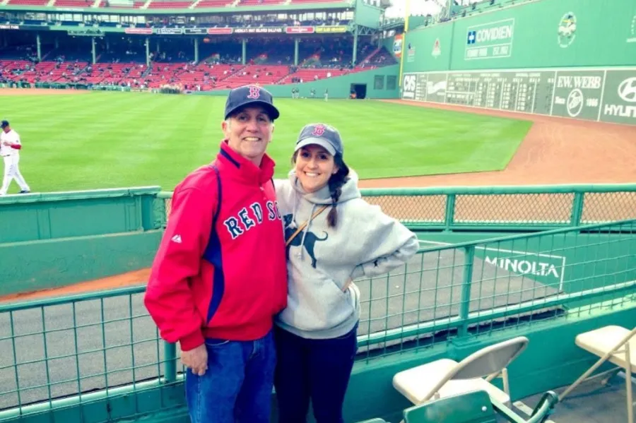 Father and daughter posing at Fenway Park