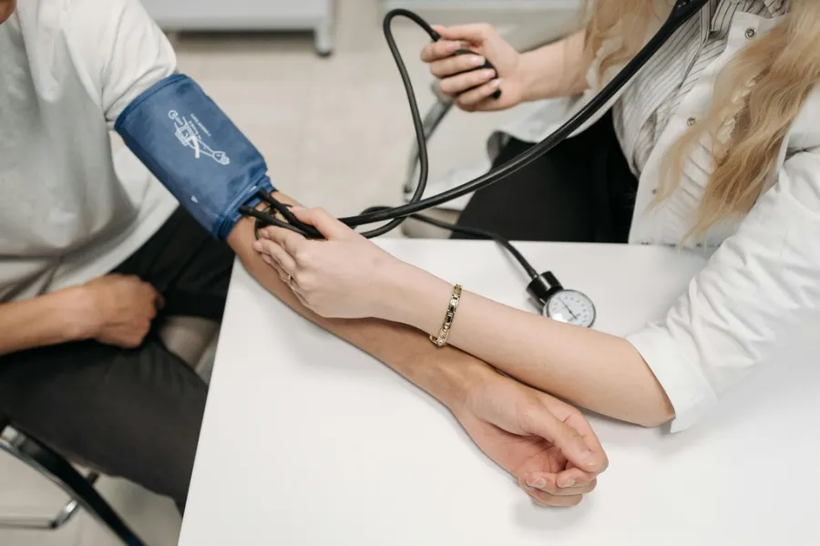 Doctor taking blood pressure