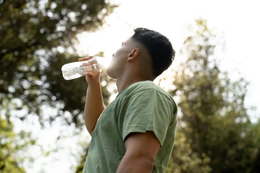 A person hydrating in the summer heat