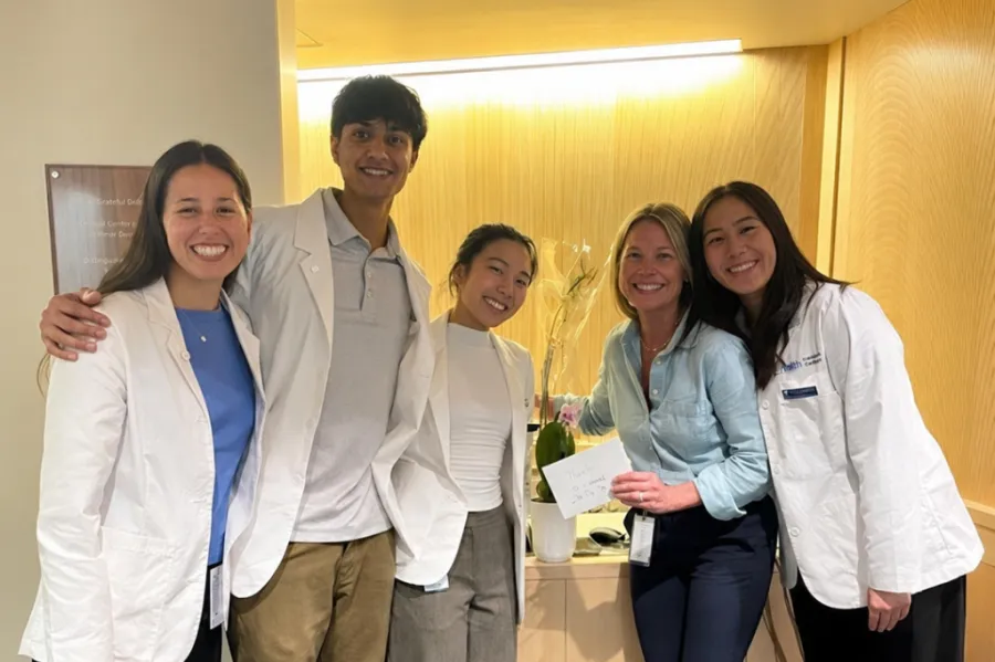First-year medical students with a nurse educator during a clinical experience that emphasizes interviewing patients and understanding the human side of medicine.