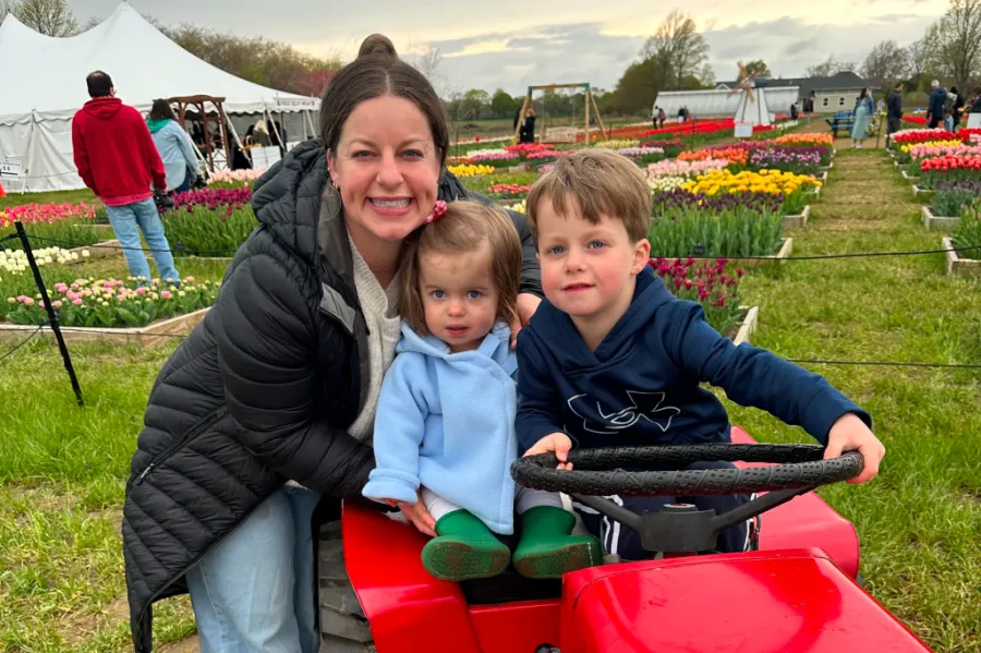 Labor and delivery nurse Sarah Brownell, RN, with her two children in a colorful tulip field.