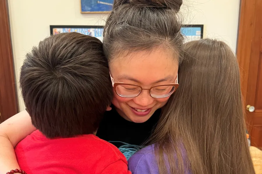 Mom Jordyne hugging her two children