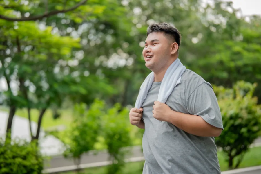 Young adult smiling after exercise in an outdoor setting