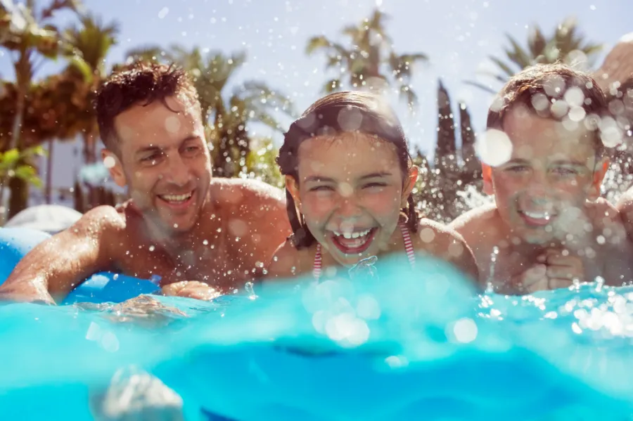 Family having fun practicing swim safety