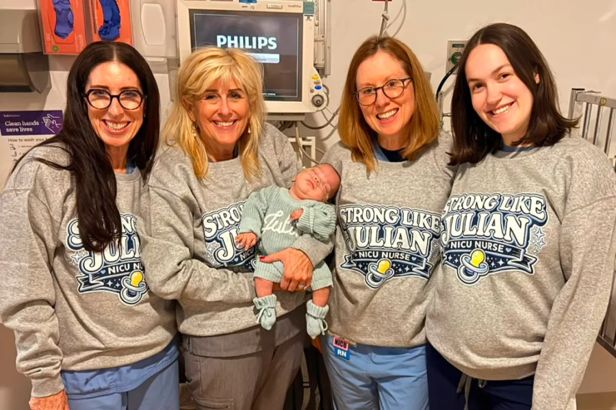 NICU nurses posing with Baby Julian