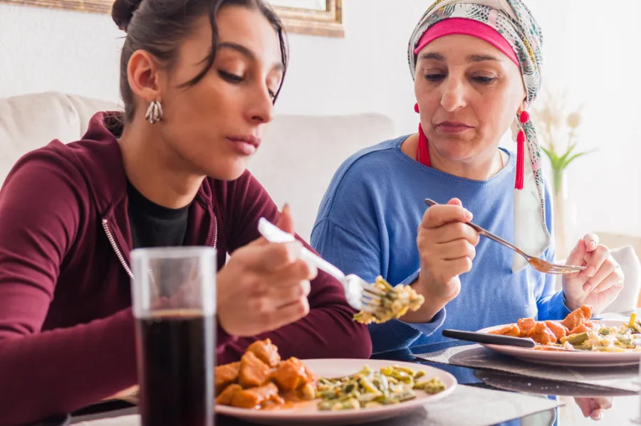 Two people eating a meal together during chemotherapy treatment
