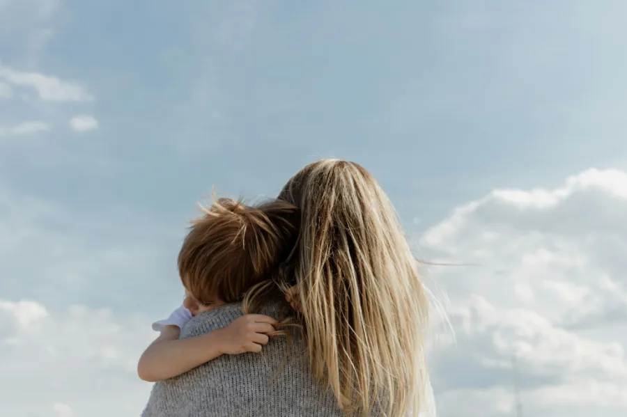 A woman hugging a child