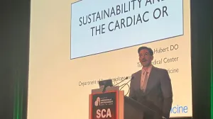 Man standing in front of large screen giving a presentation