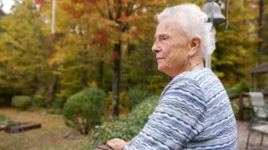 Woman stands on autumn day looking out