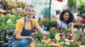 Joints women kneeling over plants