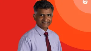 Doctor in front of color background with Tufts Medicine brand. 