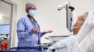 Anesthesiologist conferring with patient.