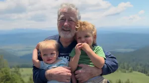 A man hugs grandchildren
