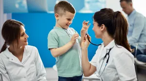 Child with clinicians, laughing