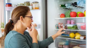 Woman looking at fridge.