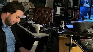 Dr. Todua plays the piano in his office.