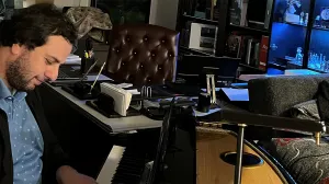 Dr. Todua plays the piano in his office.