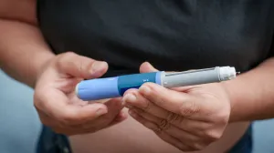 Woman holding GLP-1 medication