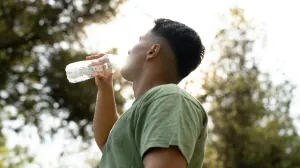 A person hydrating in the summer heat