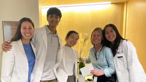 First-year medical students with a nurse educator during a clinical experience that emphasizes interviewing patients and understanding the human side of medicine.