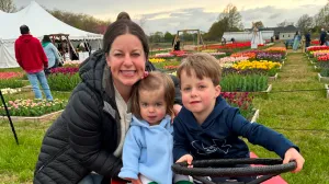 Labor and delivery nurse Sarah Brownell, RN, with her two children in a colorful tulip field.