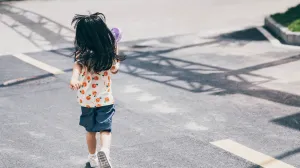 A young child crossing the street