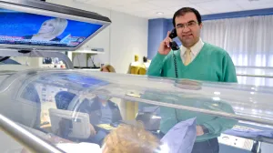 Payam Salehi, MD speaking with a patient receiving hyperbaric oxygen therapy