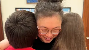 Mom Jordyne hugging her two children