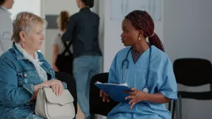 A clinician speaking with a patient in a medical clinic