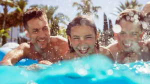 Family having fun practicing swim safety