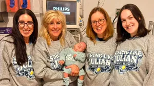 NICU nurses posing with Baby Julian