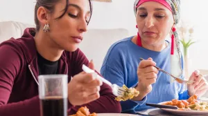 Two people eating a meal together during chemotherapy treatment
