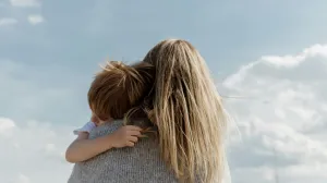 A woman hugging a child