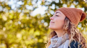 Person taking a deep breath outside in the fall air
