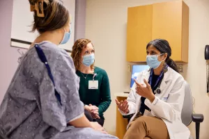 Anasuya Gunturi MD, PhD and Jennifer Gilliatt, Oncology Nurse Practioner, meet with patient at Lowell General Hospital's Women's Wellness Center.