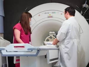 Stepahine Driver and  Evan Kyranos, both MRI Technologists, looking over and setting up MRI machine at MelroseWakefield Hospital.