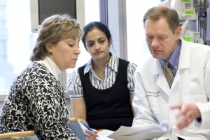 Robert Martell, MD, PhD (Director of the Neely Center for Clinical Cancer Research and Leader of the Experimental Therapeutics Program at Tufts Medical Center), discusses treatment options with patient during an appointment.