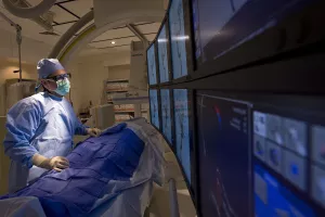 Adel Malek, MD, PhD (Chief, Division of Neurovascular Surgery) performing surgery in the Angiography Suite at Tufts Medical Center.
