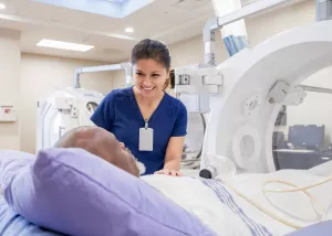 Nurse comforts patients before beginning treatment in hyperbaric chamber.