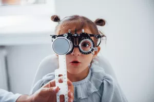 Child receiving an eye exam during an ophthalmology appointment.