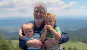 A man hugs grandchildren