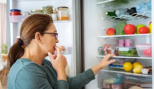 Woman looking at fridge.