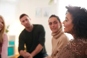 Group of people talking in therapy session