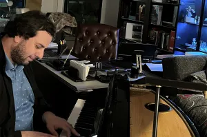 Dr. Todua plays the piano in his office.
