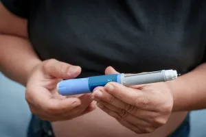 Woman holding GLP-1 medication