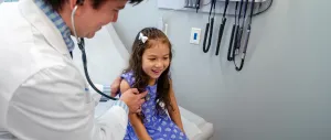 Tufts Medicine doctor with a pediatric patient