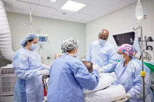 Amber Gross, SRNA (nurse assistant), Heidi MacFarlane, RN, Jason Hall, MD and Sharma Joseph, MD preparing patient for colon and rectal surgery