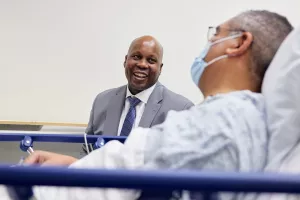 Dr. Jason Hall, Surgeon-in-Chief and Chair of the Department of Surgery at Tufts Medical Center, talking to patient before surgery.