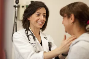 Laura Kogelman, MD, Director of the Infectious Disease and Travel Clinics at Tufts Medical Center, examines a patient during clinic appointment.